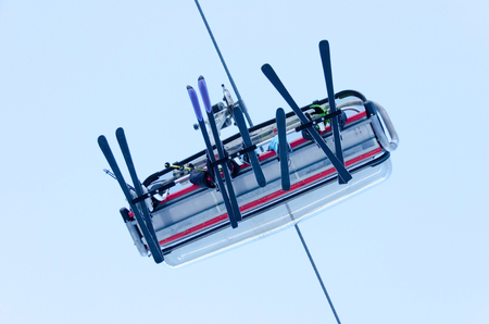ski lift with skiers from bottomの写真素材