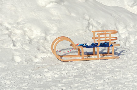 wooden sleds on snow