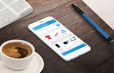 on line shopping with smart phone on wooden table relax time with coffee newspaper pencil growing marketing conceptの写真素材