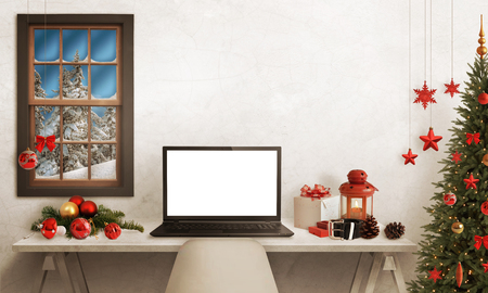Black Santa laptop on table. Christmas tree, gifts, decorations in background.の写真素材