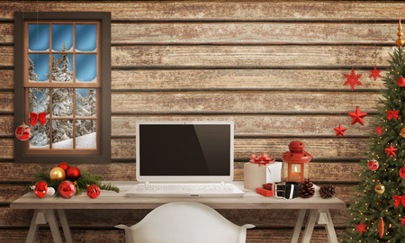 White Santa laptop on table. Christmas tree, gifts, decorations in background.の写真素材