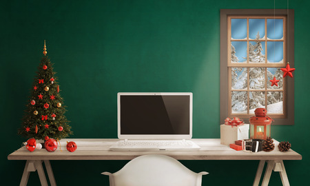 White Santa laptop on table. Christmas tree, gifts, decorations in background.の写真素材