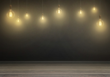 Hanging bulbs. Free space for text, wall in background.の写真素材