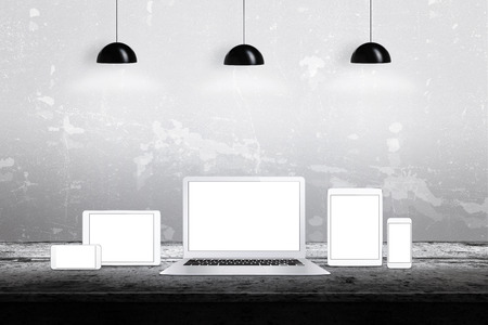 Devices with isolated white displays for responsive web promotion. Laptop, tablets, smart phones on deskの写真素材