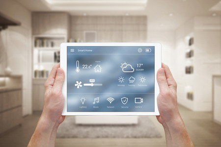 Smart home control on tablet. Interior of living room in the background. Smart home control on tablet. Interior of living room in the background.