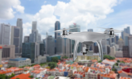 Drone quad copter with camera flying over the city center.の写真素材