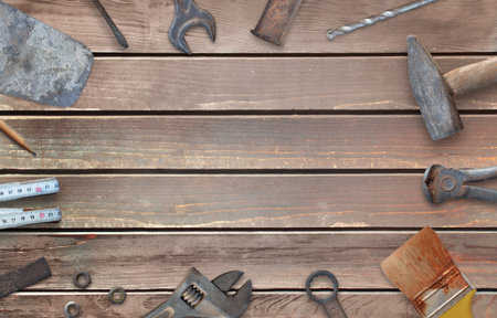 Old construction tools with free space for text. Hammer, chisel, brush, paint, wood plane, ruler,...