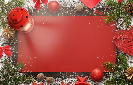 Christmas background image for greeting text with christmas decorations. Top view of board with snow, tree, tablecloth, lantern, balls, pincones, walnut, decorations.の写真素材