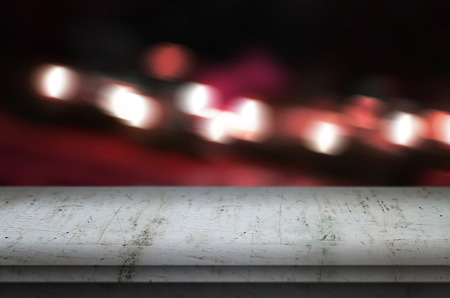Wooden table on blurred city lights background for product presentation.の写真素材