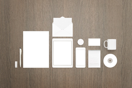 Stationery mockup scene you can use to showcase your branding, identity projects. Paper, tablet, smart phone, pen, envelope, mug, business card, badge pin, cd, pad.の写真素材