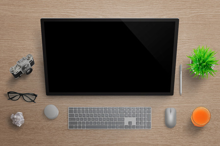 Artist, graphic designer studio with studio touch screen. Top view with camera, glasses, paper, juice, plant, keyboard, mouse, dial and pen. Wooden surface in background.の写真素材