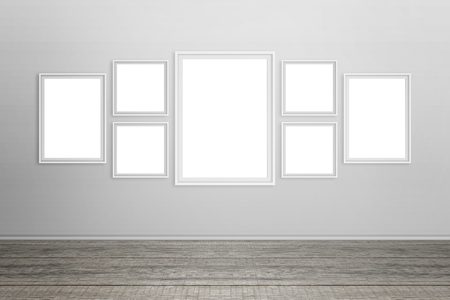 Empty white frames on wall. Isolated for mockup.の写真素材