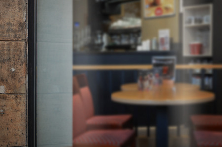Coffee shop glass door mockup. Empty space on window for add logoの写真素材