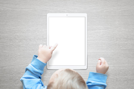 Kid learn to use tablet. Touch isolated screen for mockup.の写真素材