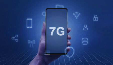 7G network abstract concept. Smart phone in woman hand with 7G text on the screen surrounded by service icons.の写真素材