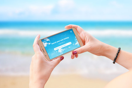 Travel tour app concept on smart phone in woman hand. Concept of travel destination search online...