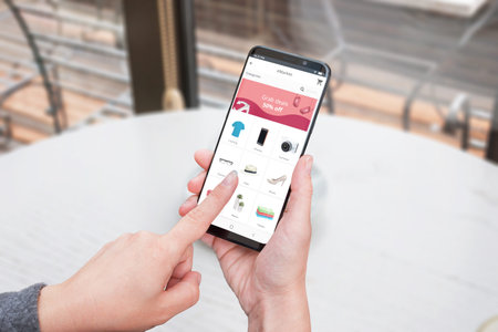Women use online store app to buy clothes, tech, furniture with a mobile phone. Close-up concept.