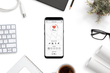 Measuring heart rate, beats per minute app on modern smart phone on office desk concept.