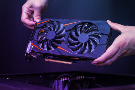 Mounting a modern graphic card to gaming computer. High performance graphics card with two coolers....