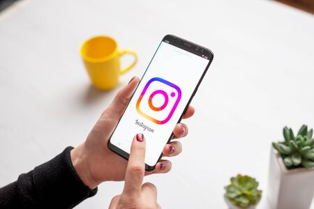 Sarajevo, Bosnia and Herzegovina - December 7, 2019: Girl uses the Instagram app on mobile phone close-upのeditorial素材