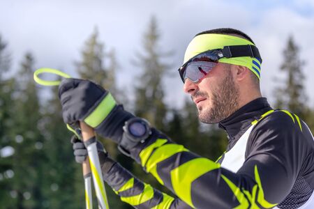Profile of a male nordic skier in a cross-country raceの写真素材