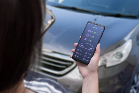 Car status information on the mobile app. Flat app design concept. Phone placed on the car seat
