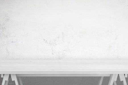 Clean white wooden desk for product promotion. Blue wall in background. Front view