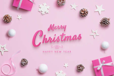Merry Christmas and Happy New Year greeting card with Christmas decorations on pink pastel surface. Top view, flat layの写真素材