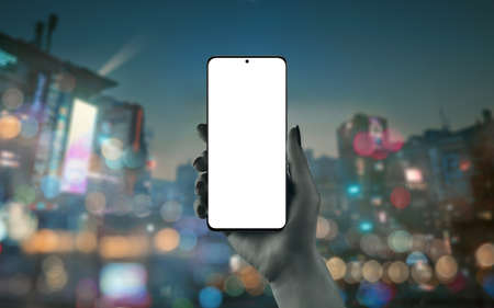 Phone mockup in woman hand with city lights in backgroundの写真素材