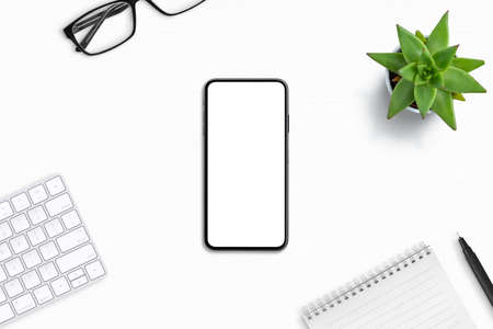 Phone mockup on office desk composition. Isolated screen for app design promotionの写真素材