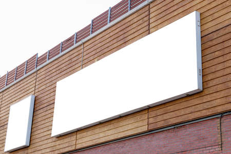 Large wide billboard mockup on building wall for marketing campaign promotionの写真素材