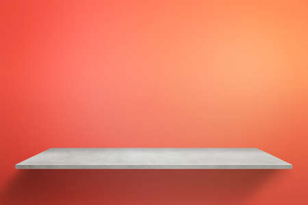 Empty table with red wall in backgroundの写真素材