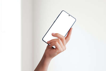 Girl hand shows smart phone mockupの写真素材