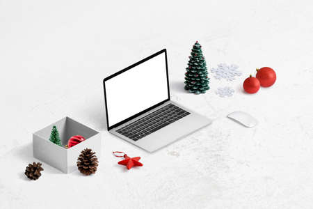 Online shopping for Christmas gifts concept. Laptop mockup, gift box and decorations beside.の写真素材