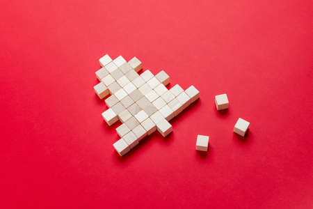 Christmas tree made of wooden cubes on red surface. Concept of children's games and the joys of the upcoming Christmas holidaysの写真素材