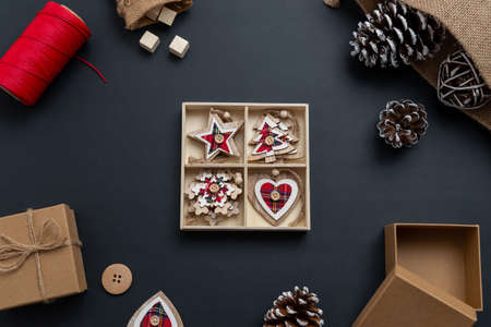 Unpacking Christmas decorations. Christmas composition with small wooden decorations for the Christmas tree. Top view, flat layの写真素材