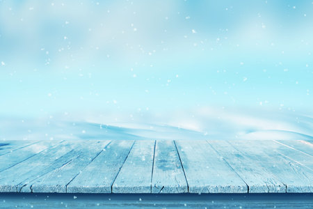 Empty wooden desk with snow in the background. Cold, winter scene for product promotionの写真素材