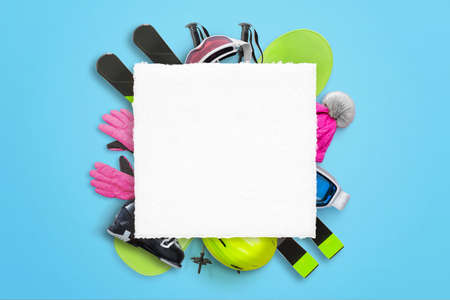 Blank square paper for text, logo promotion with ski equipment in background. Top view, flat lay compositionの写真素材