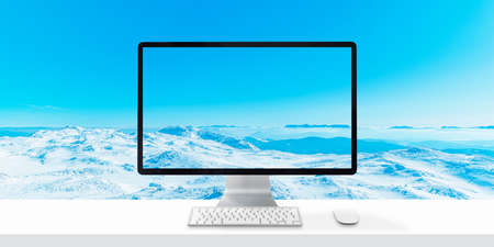 Computer display on desk with mountain horizon in background. Winter travel conceptの写真素材