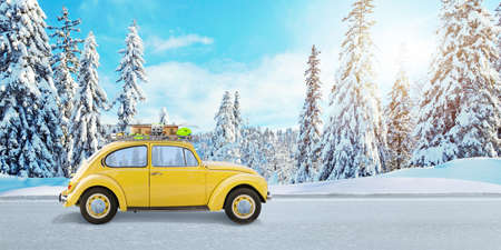 Yellow car on the road with ski equipment. The concept of a winter holiday trip to the mountainsの写真素材