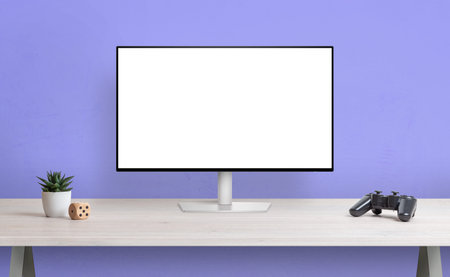 Computer display with isolated screen for mockup on desk. Gamepad, plant and cube beside. Gamer desk...