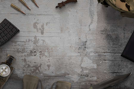 Military equipment on rough surface with copy space in the middle. Army top view, flat lay compositionの写真素材