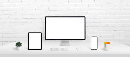 Responsive devices display mockup on work desk. Computer display, smart phone and tablet on work desk with isolated screen for app or web page presentationの写真素材