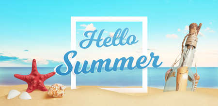 Hello summer text on beach sand surrounded by sea star, shells and message in the bottle. Tropical vacation conceptの写真素材