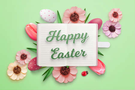 Happy Easter greeting card with notebook and Easter eggs and flowersの写真素材