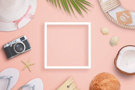 Summer travel composition with white paper frame in the middle and traveler accessories, palm leaf,...