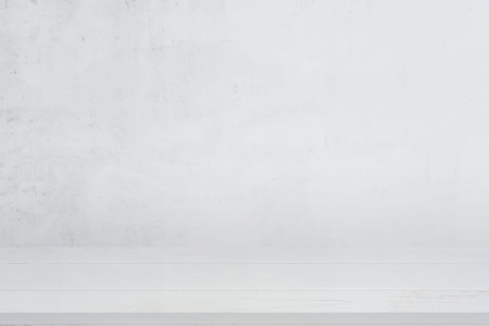 Clean white wooden desk with white wall in background for product presentation
