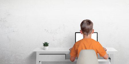 Boy typing on a laptop computer. The concept of sending an email or corresponding with friends....
