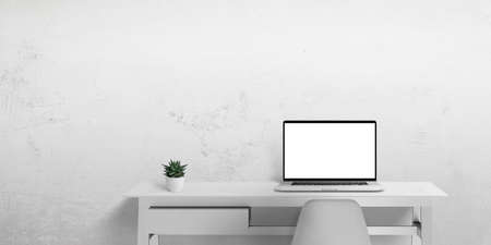 Laptop computer on work desk with isolated in white display screen for web page promotion. Clean space beside for copyの写真素材