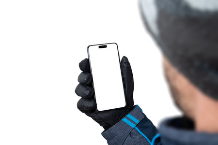 Mockup of a smartphone in the hands of a man in a winter gloveの写真素材